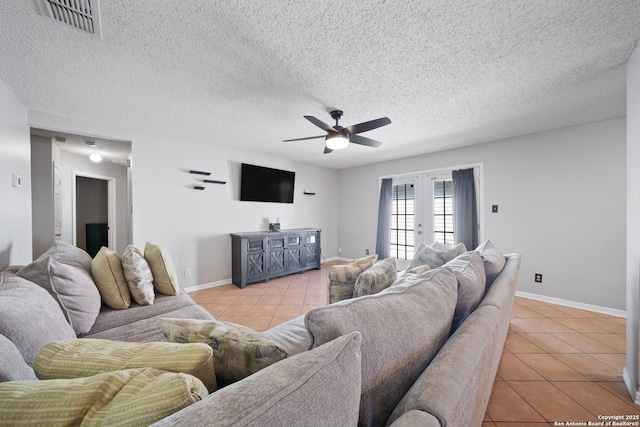 living area with a ceiling fan, french doors, baseboards, and light tile patterned floors