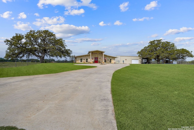 ranch-style house with driveway and a front lawn