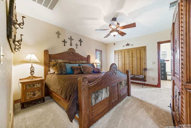 bedroom with baseboards, visible vents, a ceiling fan, and light colored carpet