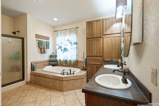 full bath with a stall shower, a garden tub, and a sink