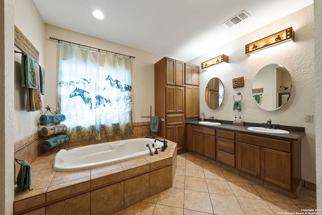 full bathroom featuring a garden tub, a sink, visible vents, and tile patterned floors