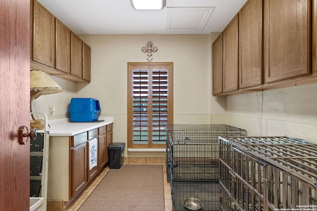 kitchen with brown cabinetry and light tile patterned flooring