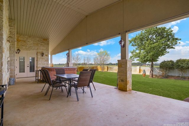 view of patio / terrace with a fenced backyard, outdoor dining area, and french doors