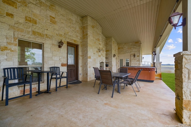 view of patio / terrace with a hot tub