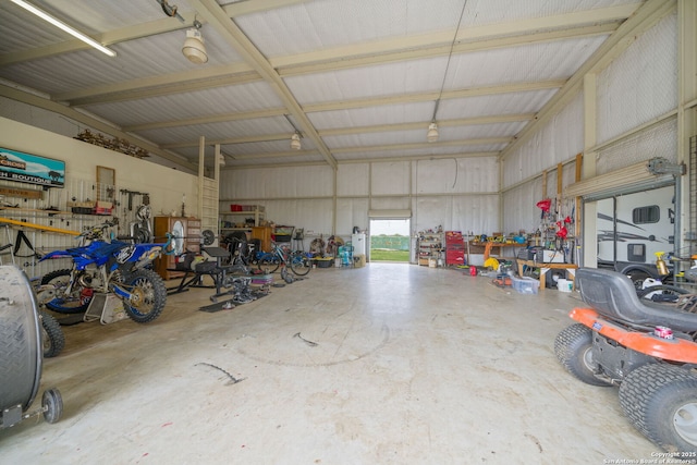 garage featuring a workshop area and metal wall