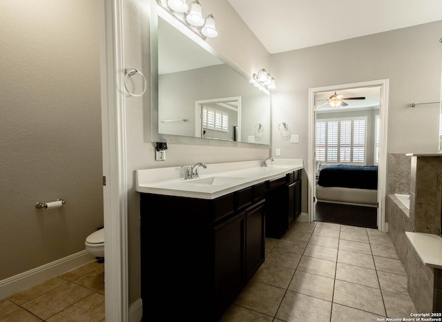 full bathroom with double vanity, a sink, toilet, and tile patterned floors