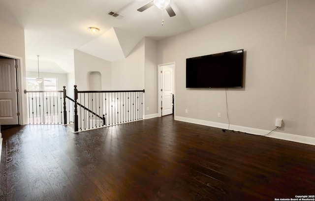 interior space featuring vaulted ceiling, ceiling fan, baseboards, and wood finished floors