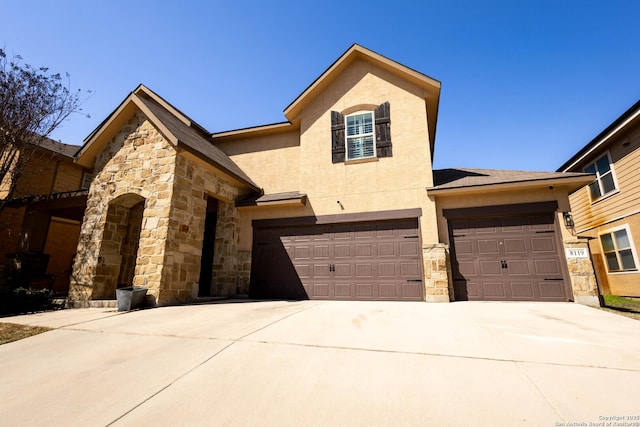 view of front of property featuring concrete driveway, stone siding, an attached garage, and stucco siding