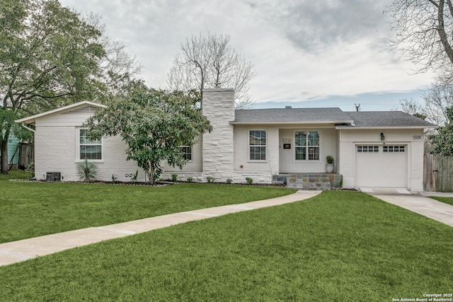 ranch-style home with an attached garage, fence, driveway, a chimney, and a front yard