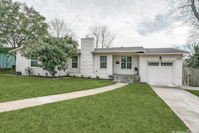 ranch-style house featuring brick siding, a chimney, a garage, driveway, and a front lawn