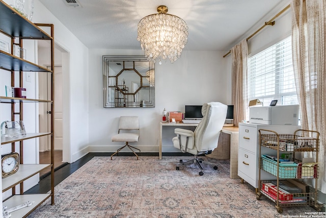 home office with a chandelier, wood finished floors, and baseboards