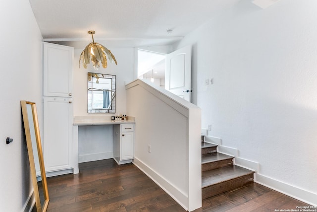 staircase with wood-type flooring and baseboards