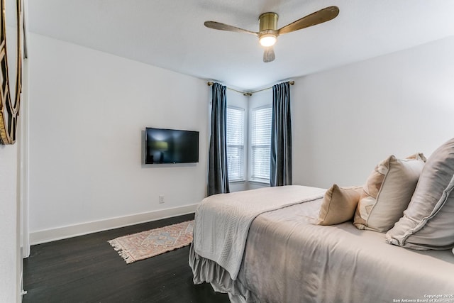 bedroom with dark wood-style flooring, ceiling fan, and baseboards