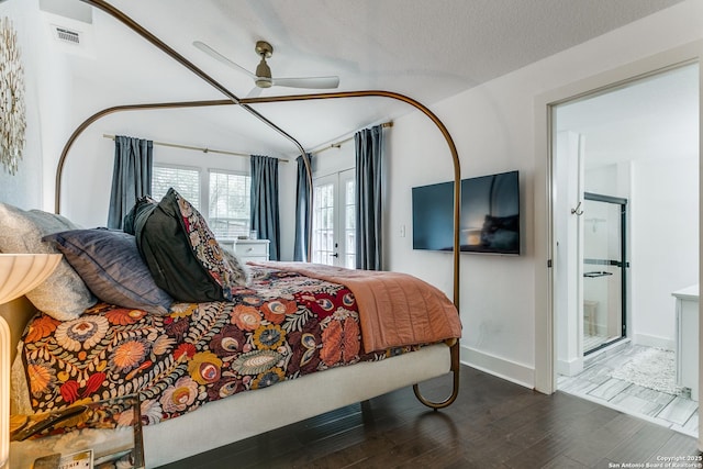 bedroom with a textured ceiling, wood finished floors, visible vents, baseboards, and a ceiling fan