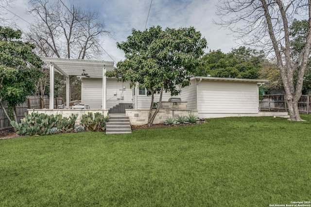 rear view of house featuring a patio, ceiling fan, fence, a yard, and a pergola