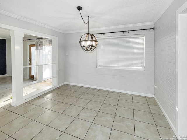 unfurnished dining area with a textured ceiling, a chandelier, light tile patterned flooring, brick wall, and ornamental molding