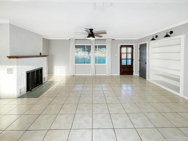 unfurnished living room with light tile patterned floors, ornamental molding, a textured ceiling, built in shelves, and a fireplace