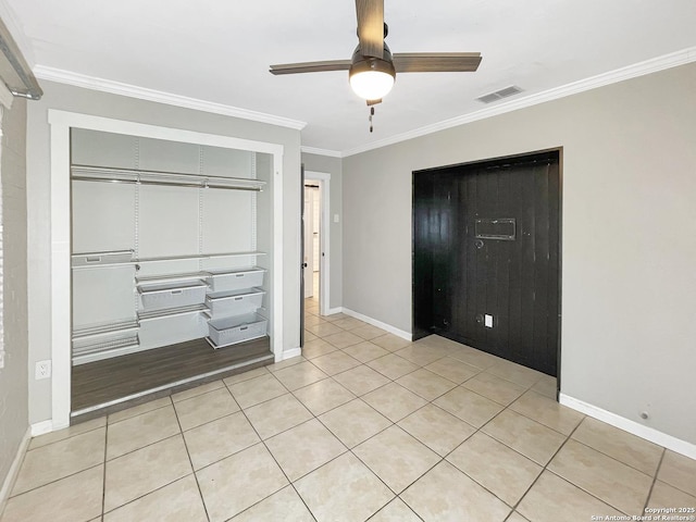 unfurnished bedroom with light tile patterned floors, visible vents, baseboards, a closet, and crown molding