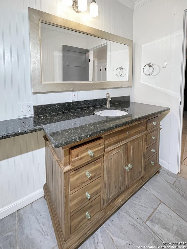 bathroom with marble finish floor, vanity, and crown molding