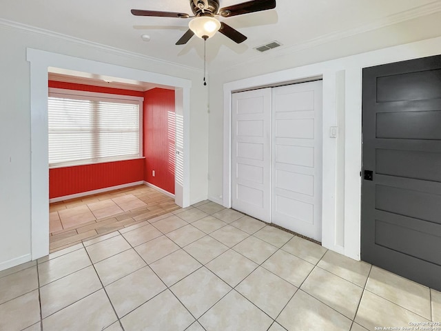 unfurnished bedroom with a closet, visible vents, crown molding, and ceiling fan