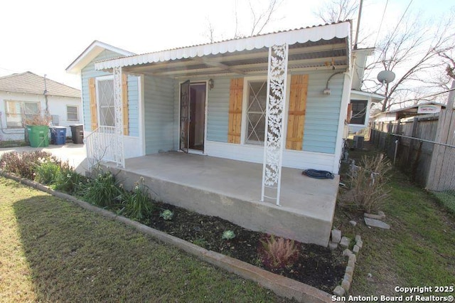 exterior space with fence and metal roof