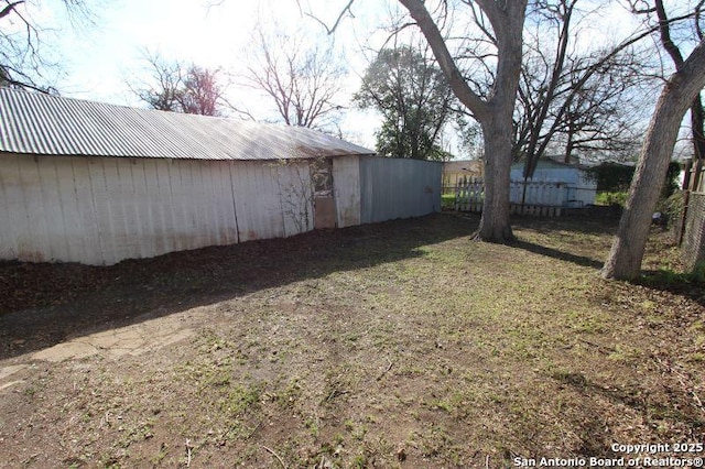 view of yard featuring an outbuilding and an outdoor structure