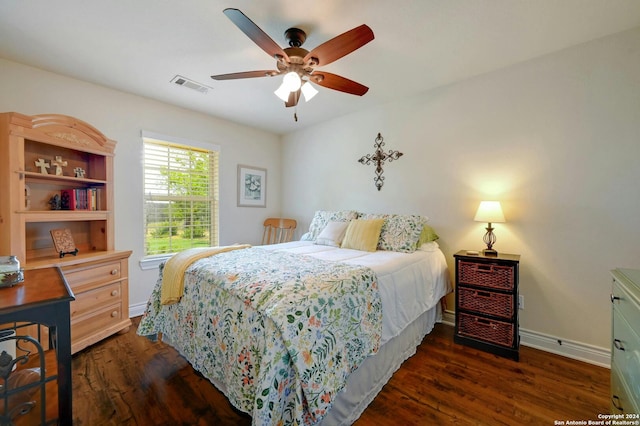 bedroom featuring dark wood-style floors, a ceiling fan, visible vents, and baseboards