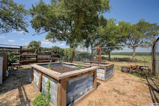 view of yard with a vegetable garden and fence