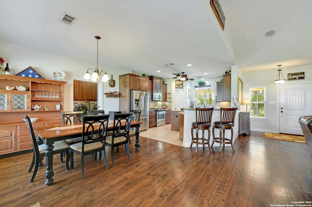 dining space with recessed lighting, ceiling fan with notable chandelier, visible vents, baseboards, and light wood-style floors