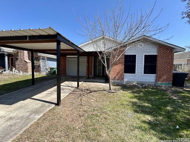 single story home with a garage, concrete driveway, brick siding, and a front lawn