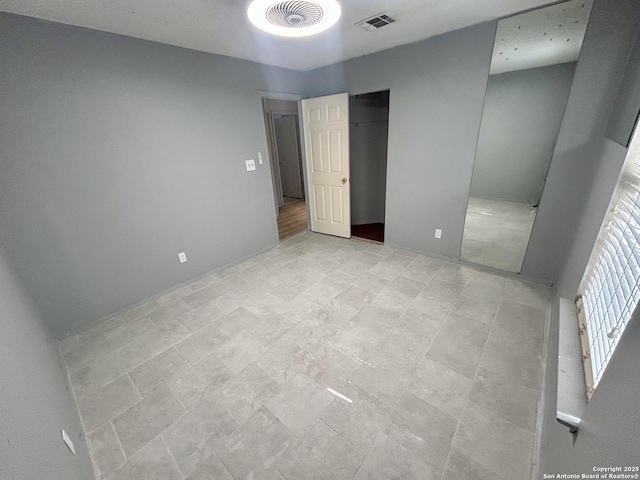 unfurnished bedroom featuring visible vents