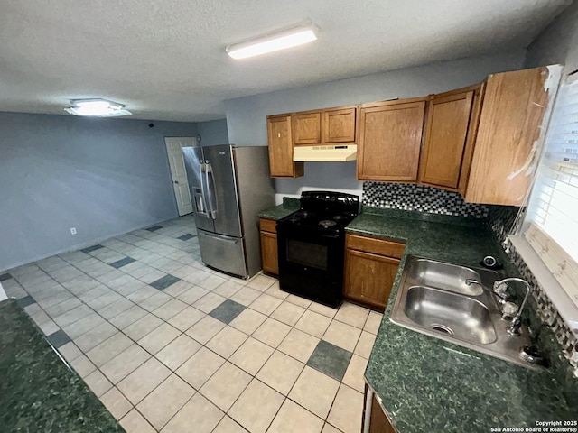 kitchen with stainless steel fridge, brown cabinetry, black electric range, under cabinet range hood, and a sink