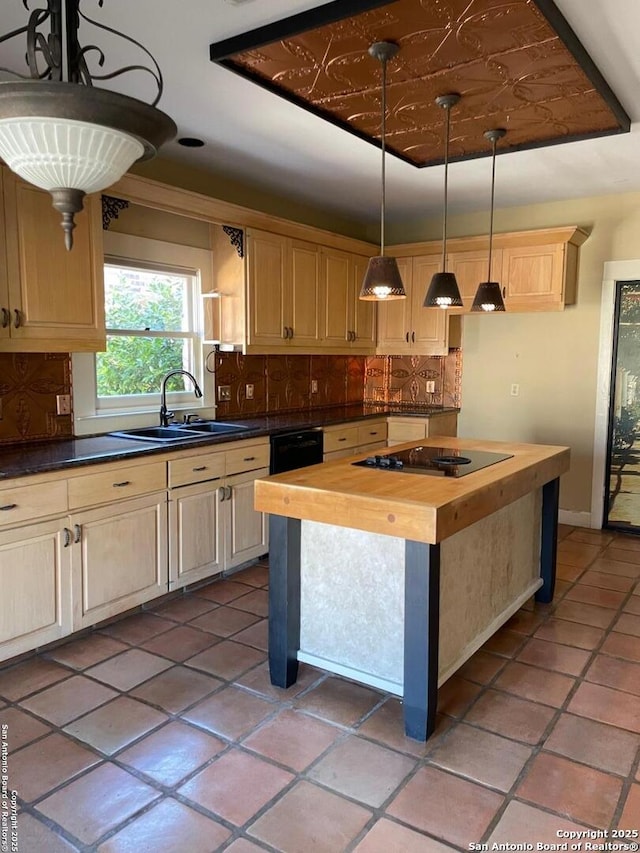 kitchen featuring backsplash, black electric stovetop, wooden counters, and a sink