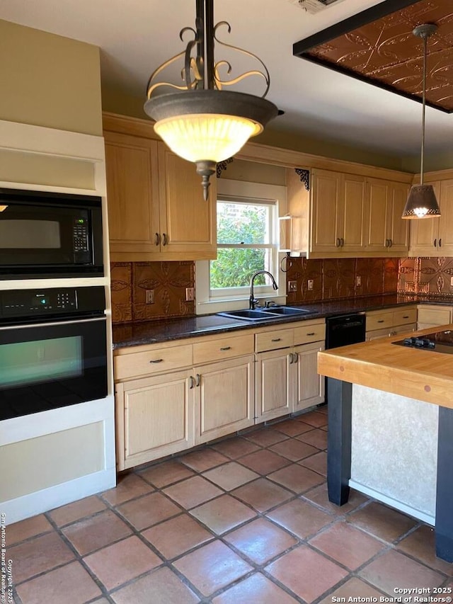 kitchen with black appliances, butcher block counters, a sink, and tasteful backsplash