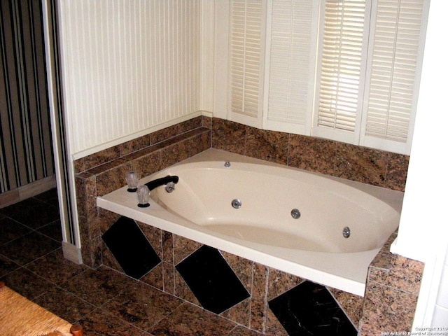 bathroom featuring a tub with jets