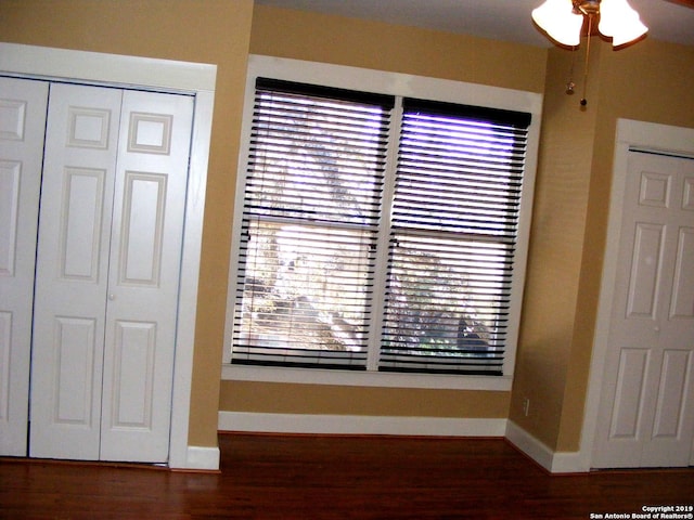 interior details featuring wood finished floors and baseboards