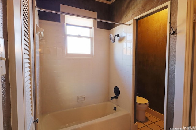 bathroom featuring bathing tub / shower combination, tile patterned flooring, and toilet