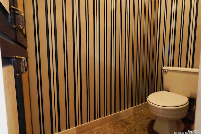 bathroom featuring toilet and tile patterned floors