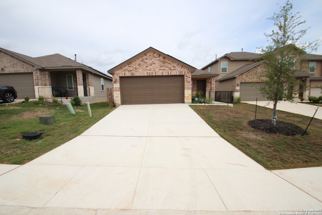 view of front of house featuring driveway, brick siding, an attached garage, and a front yard