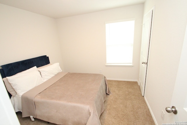 carpeted bedroom featuring baseboards