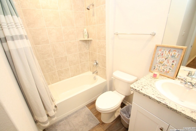 full bath featuring vanity, shower / tub combo, wood finished floors, and toilet