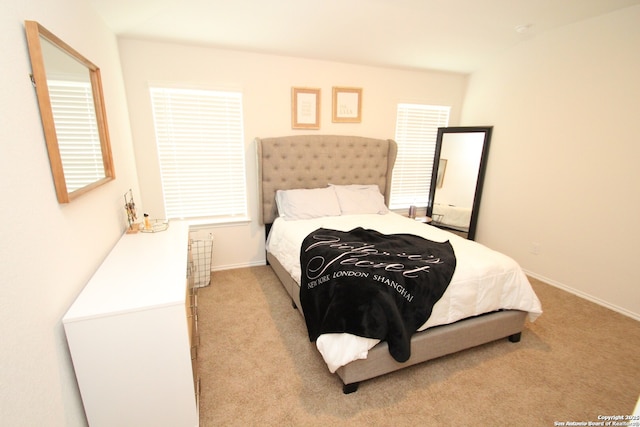 carpeted bedroom featuring baseboards