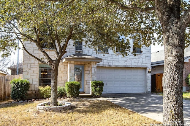 traditional-style house featuring a garage, stone siding, fence, and concrete driveway