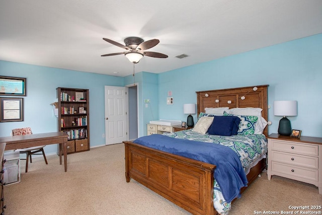 bedroom with visible vents, ceiling fan, and light carpet