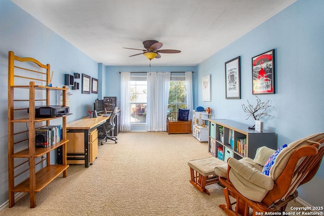 living area featuring a ceiling fan and light carpet