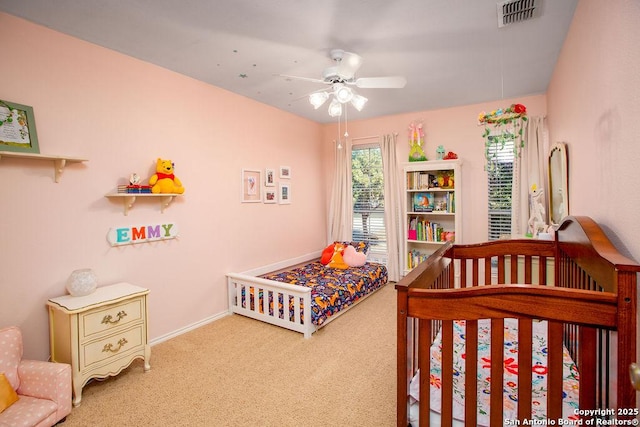 bedroom featuring ceiling fan, carpet floors, visible vents, and baseboards