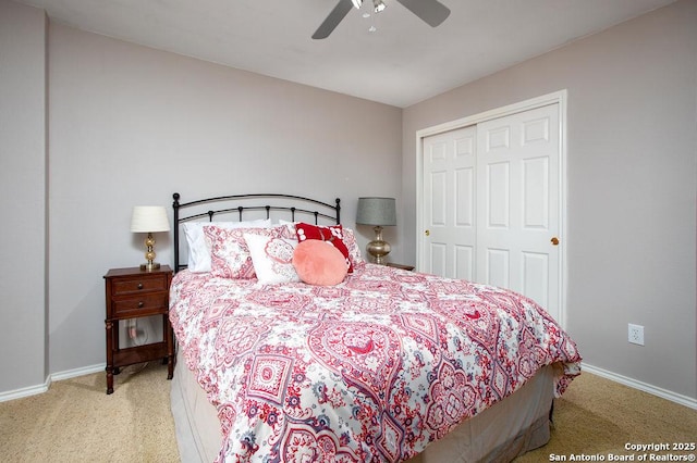 carpeted bedroom featuring a closet, a ceiling fan, and baseboards