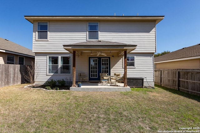 rear view of property featuring a patio area, a fenced backyard, ceiling fan, and a lawn