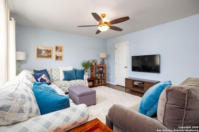 living room with wood finished floors and a ceiling fan