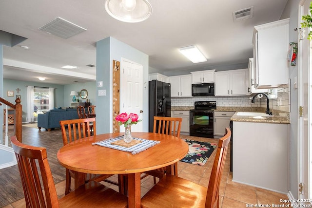 dining space with visible vents and light tile patterned floors